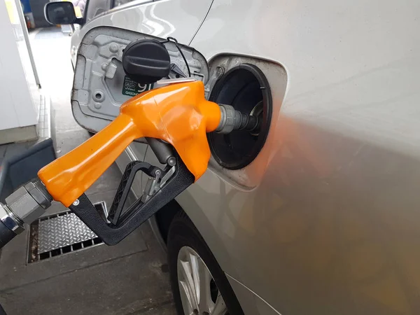 Gas pump filling up a car