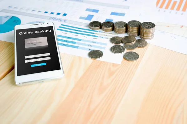 Stack coin and smartphone on table with statistic graph diagram — Stock Photo, Image