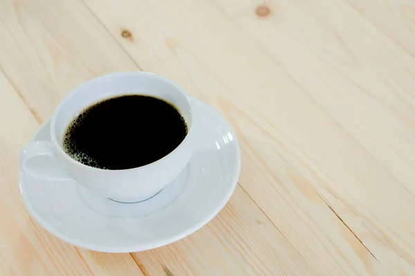 Black coffee cup on wood background — Stock Photo, Image