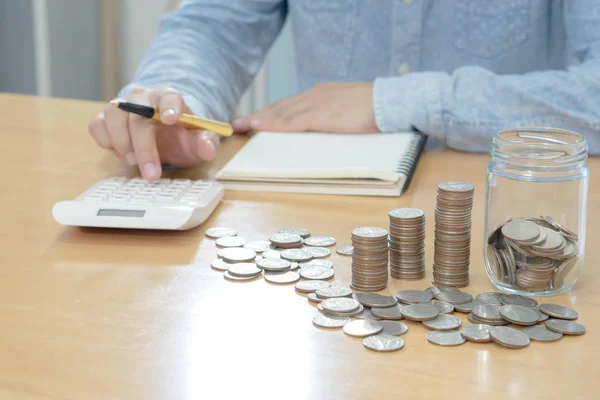 Men are Saint documents about save money with some coins calcula — Stock Photo, Image