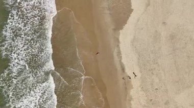 Baş döndürücü bir hava aracı, kumlu bir sahilde huzur içinde yatan hamile bir kadını yakalıyor. Görüntüler anneliğin ve doğanın güzelliğini ve huzurunu vurguluyor..