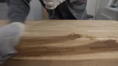 Bir ahşap ile çalışan koruma eldiven giyen bir adam çekim kapatın.