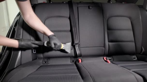 Empleado sin rostro cuidadosamente aspirando asiento de coche — Vídeos de Stock