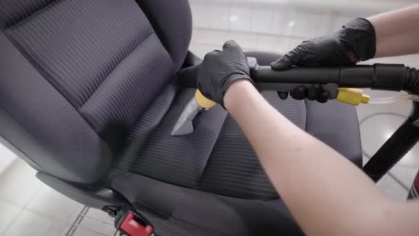 Person cleaning folds of car seat — Stock Video