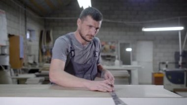 Adam metal astar paneliyle ölçme garajında genel ayakta