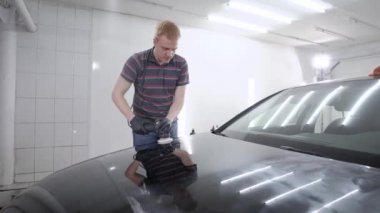 Araba servisi tampon siyah otomobil beyaz garaj içinde taşlama çalışanı