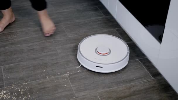 Woman setting robot vacuum cleaner — Stock Video