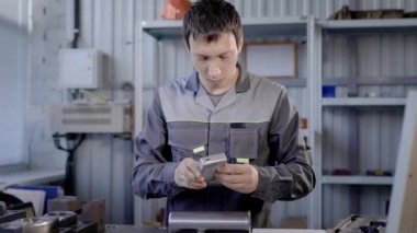 Metal parçalar üretimi. Laboratuvar uzmanı bir ürünün fiziksel özelliklerini ölçer.