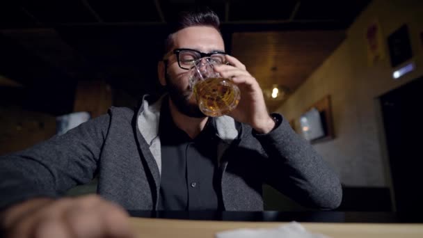 Portret przystojny stylowy facet w okularach z szklankę whisky, okrzyki w aparacie. — Wideo stockowe