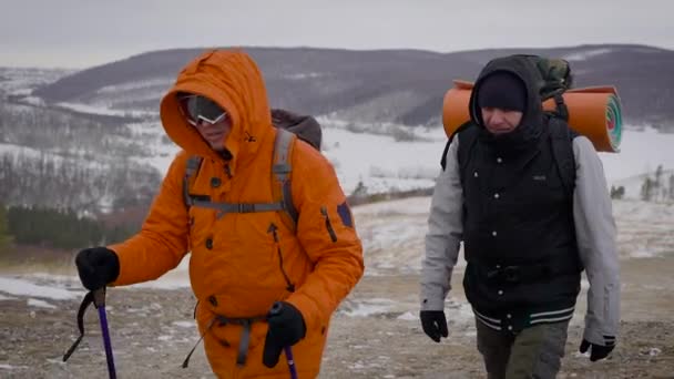 A team of two men go on an expedition. Difficult conditions of the north, each step is dangerous and difficult. — Stock Video