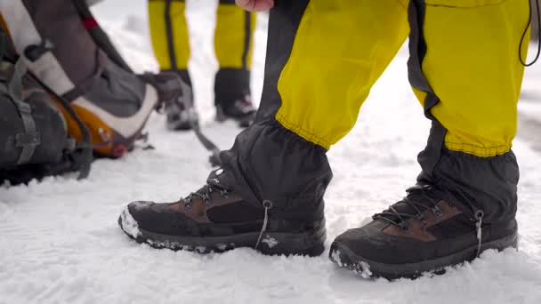 Cara ativo coloca polainas caminhadas em suas pernas antes de ir caminhadas . — Vídeo de Stock