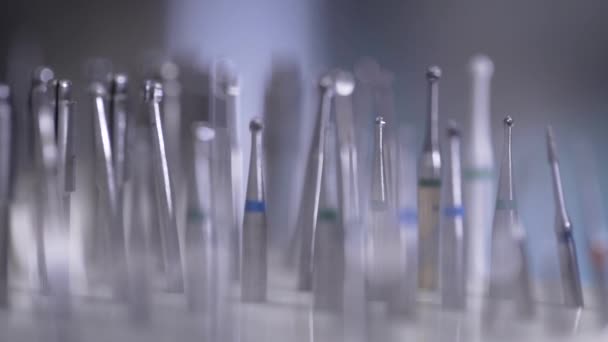 Macro shot of various drills and drills for dentistry. Sterile tips are in order. — Stock Video