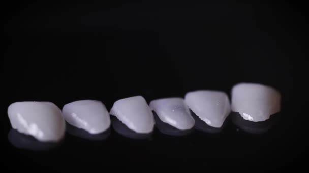 A macro shot of dental veneers. Veneers are special tooth pads that carry an aesthetic function. Modern precision manufacturing allows you to create the perfect smile. — Stock Video