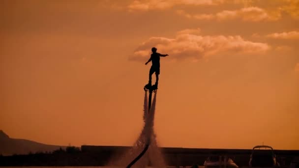 Person propelling through air on flyboard — Stock Video