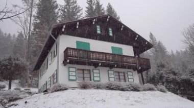 Beautiful house on the hill. Snowfall in mountainous areas.