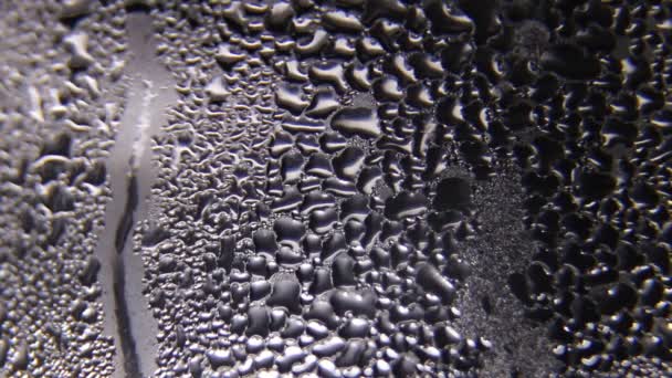 Drops of water flow down the glass. Raindrops on the window. — Stock Video