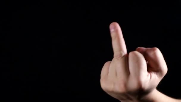 Man shows middle finger on black background. — Stock Video