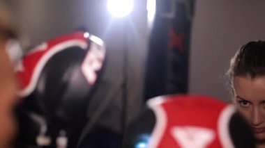 Ringde dövüşen iki bayan boksör. Kızlar antrenmanda yumruk pratiği yapar.