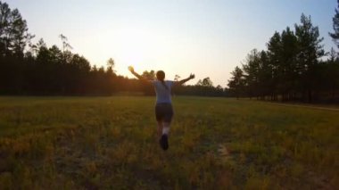 Neşeli kız, silah gün batımında alan boyunca çalışan dışarı