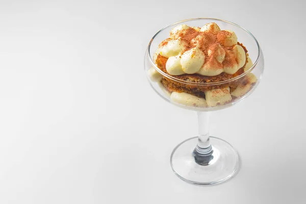 Tiramisu cake dessert in a glass over white background. Traditional Italian dessert isolated on white. Italian cuisine concept.