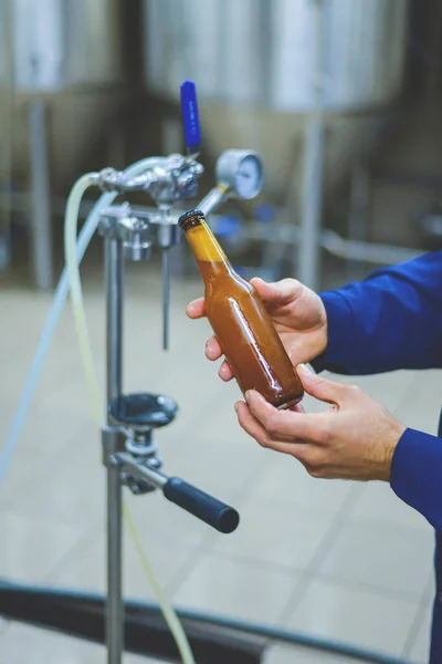 Beer bottle filled with beer. Moder brewery concept. Process of making beer. Modern beerhouse, craft brewery.