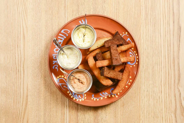 Crouton stack in a porcelain plate with different kinds of sauce. Delicious snack for beer. Ukrainian cuisine concept. — Stock Image Crouton Stack Porcelain Plate Different Kinds Sauce Delicious Snack Beer Royalty Free Stock Images
