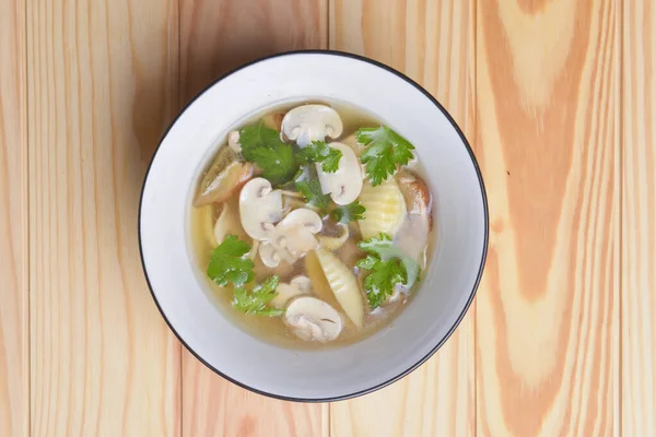Bowl of chiken broth mushroom soup with mushrooms and macaroni served in a white bowl over rustic wooden table background. Delicious dinner, Italian cuisine concept. Seasonal autumn menu. — Stock Image Bowl Chiken Broth Mushroom Soup Mushrooms Macaroni Served White Bowl Royalty Free Stock Photos