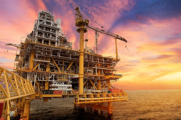 Üretim petrol ve doğal gaz offshore İnşaat Platformu. Petrol ve gaz endüstrisi. Üretim platformu ve işletme sürecinde günbatımı zamanı