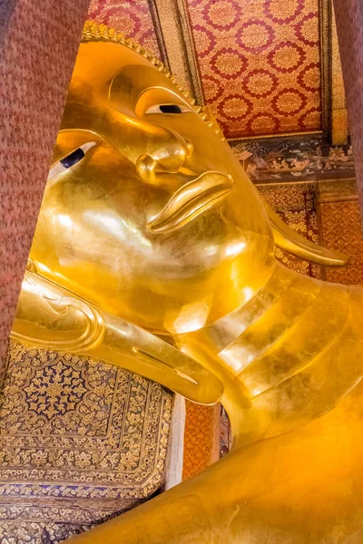 Face of Reclining Buddha of Wat Pho.  Reclining Buddha represents the entry of Buddha into Nirvana and the end of all reincarnations