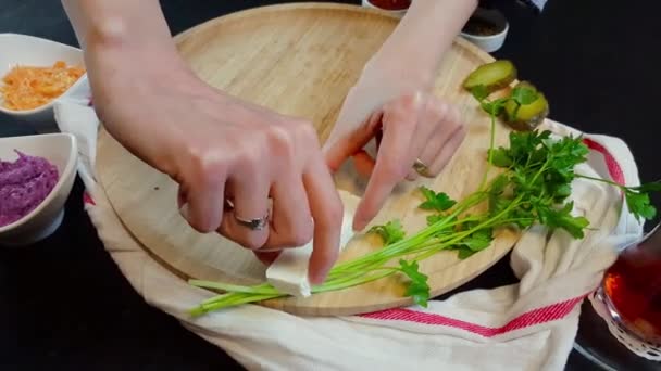 Woman prepping meal scene for a shoot on a wooden board — Stock Video