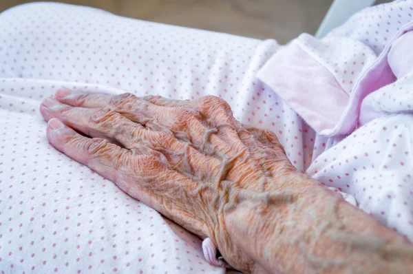 Very old senior woman hand, wrinkled skin