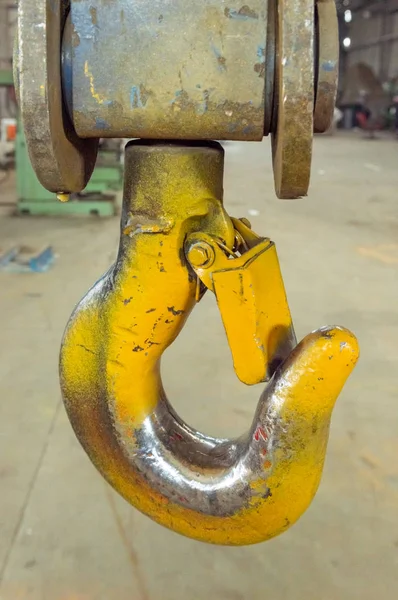 Fechar-se de um gancho guindaste de elevação amarelo em uma fábrica — Fotografia de Stock