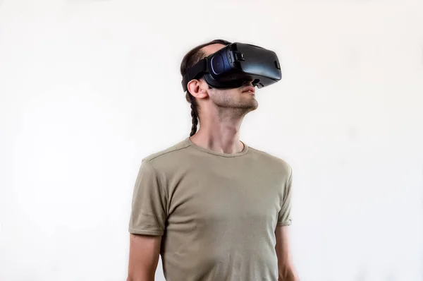 Man exploring modern technology virtual reality with head mounted display on white background