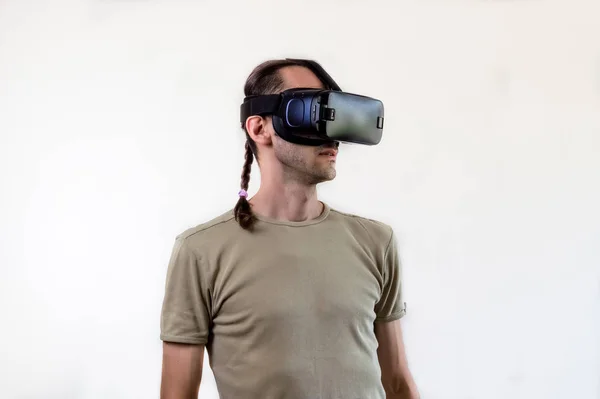 Man exploring modern technology virtual reality with head mounted display on white background