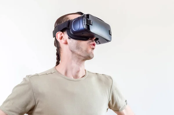 Man exploring modern technology virtual reality with head mounted display on white background