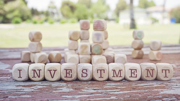 INVESTMENT inscription made of scramble game cubes
