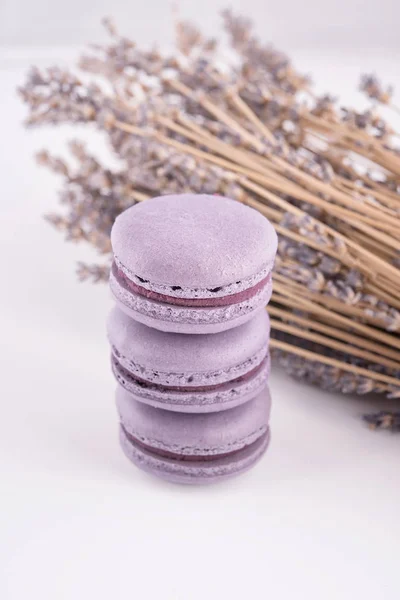 Macarons purple on white background and lavender, top view