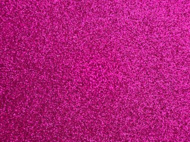 Pembe parıltılı bir dokunun yakınlaşması ışıl ışıl ve parlak bir arka plan yaratır. Yüzeyde küçük yansıtıcı parçacıklar bulunur ve bu da onu festival, kutlama veya dekoratif projeler için ideal kılar..
