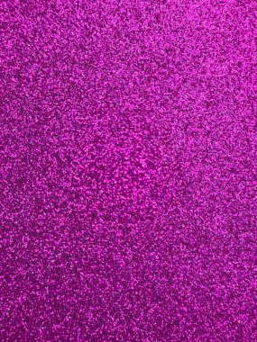 Parlak pembe parıltılı dokunun ışıl ışıl yakın görüntüsü. Parıldayan parçacıklar tüm çerçeveyi canlı bir renkle doldurarak parti, kutlama, zanaat veya kozmetik için uygun bir şenlik ve göz alıcı bir arka plan oluşturur.