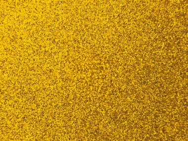 Makro fotoğraf, sarı sim parçacıklarıyla kaplı yoğun, parıldayan bir yüzey gösteriyor. Işıltılı soyut arka plan canlı, şenlikli bir görünüm yaratıyor, dekoratif, kutlama ve sanatsal tasarım projeleri için ideal..