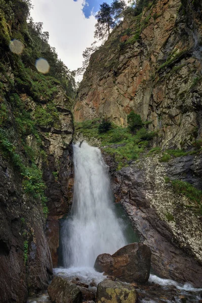 Waterfall on the rocky slopes of the Caucasus Mountains in Russia.