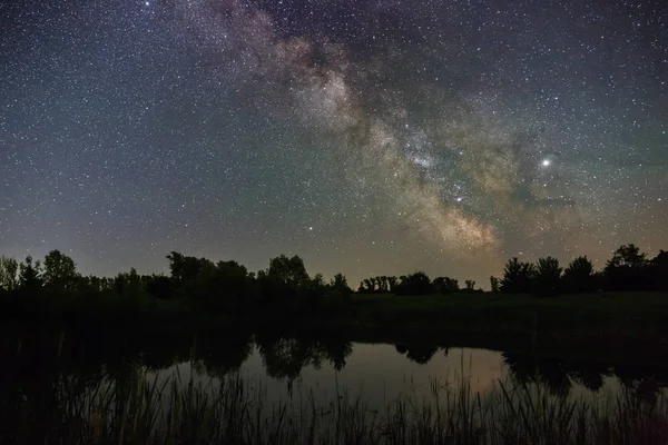 Stars in the sky at night. Bright milky way over the lake.