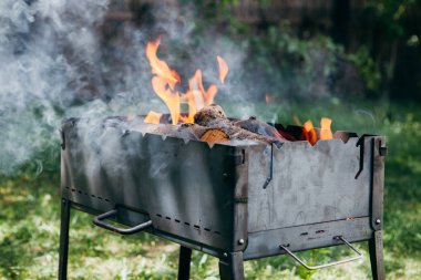 Yaz aylarında bahçede yanan barbekü ızgara 