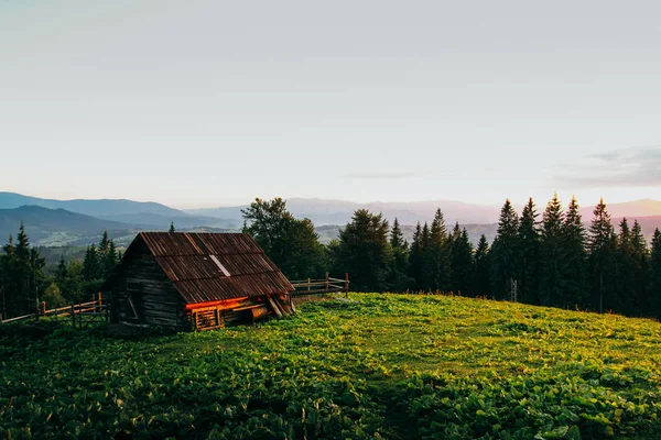 Casa de campo do pastor nas montanhas ao pôr do sol — Fotografia de Stock