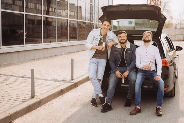 Un montón de amigos hablando en el maletero del coche. Verano. — Foto de Stock