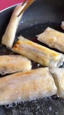 bananas in rice paper. fry bananas in a pan with sunflower oil. High quality 4k footage