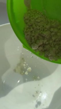 Bright green grated horseraddish wasabi spicy sauce texture circle rotation close up top view. High quality 4k footage