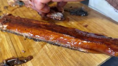 Grilled eel preparation Man guts and fillets live eels on a table outside of eel restaurant in Narita, Japan. High quality 4k footage