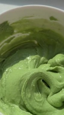 Bright green grated horseraddish wasabi spicy sauce texture circle rotation close up top view. High quality 4k footage