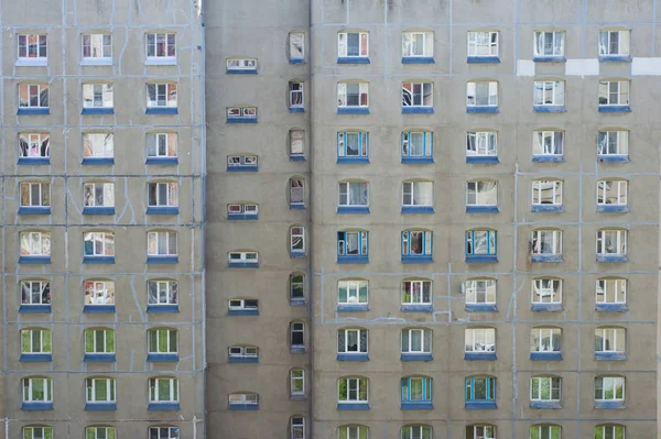Facade of a multi-storey panel building. Fragment of wall of house. Typical block of flats in Russia